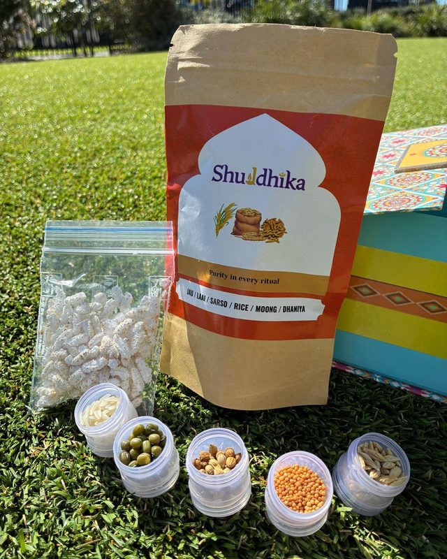 Orange Shuddhika pouch with laai and jars of grains and seeds