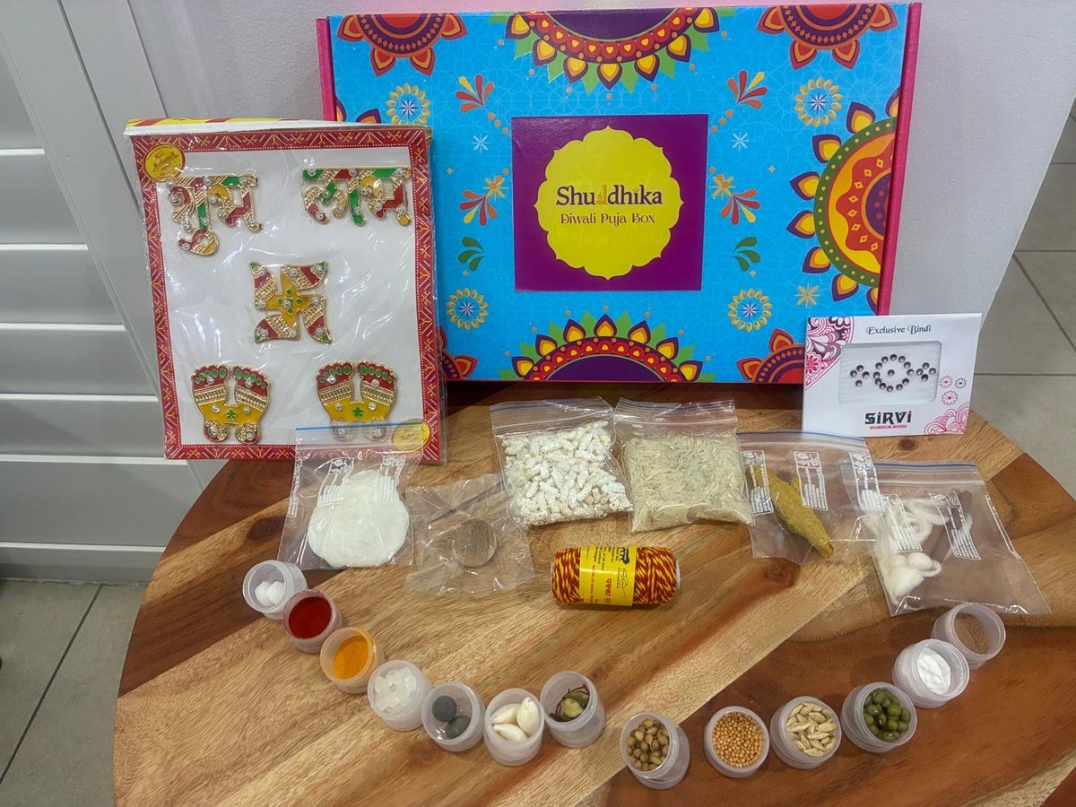 The Diwali Puja Box with its contents laid out: a sticker sheet, bindi, moli and small jars of samagri