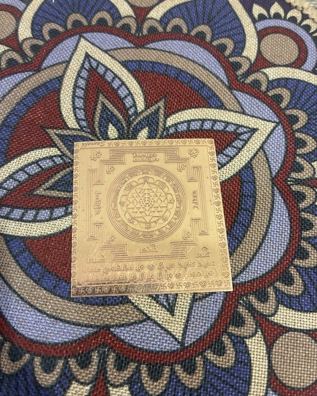 A Shri Yantra on a mandala mat